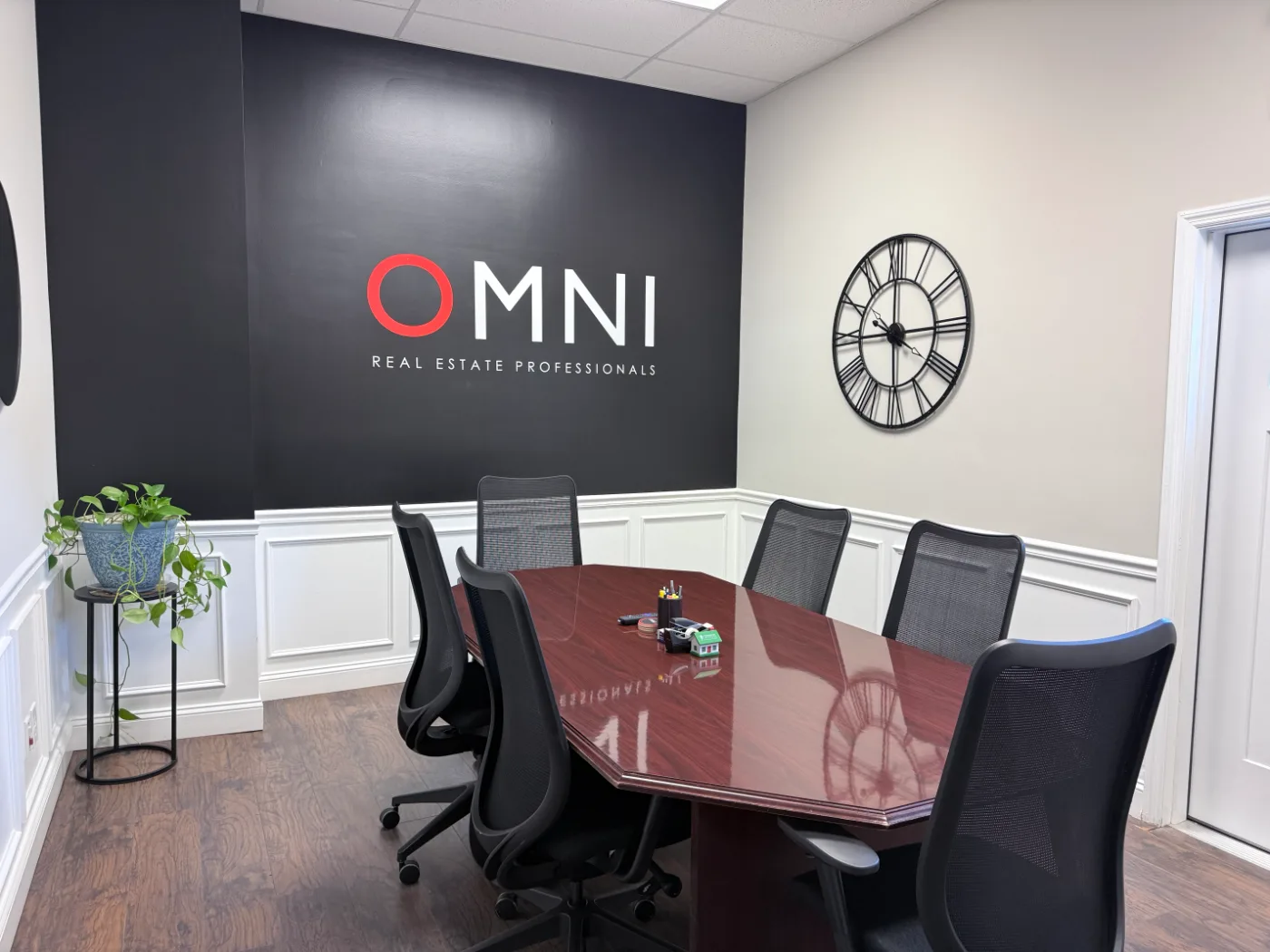 OMNI Real Estate Professionals conference and settlement room with the black OMNI feature wall